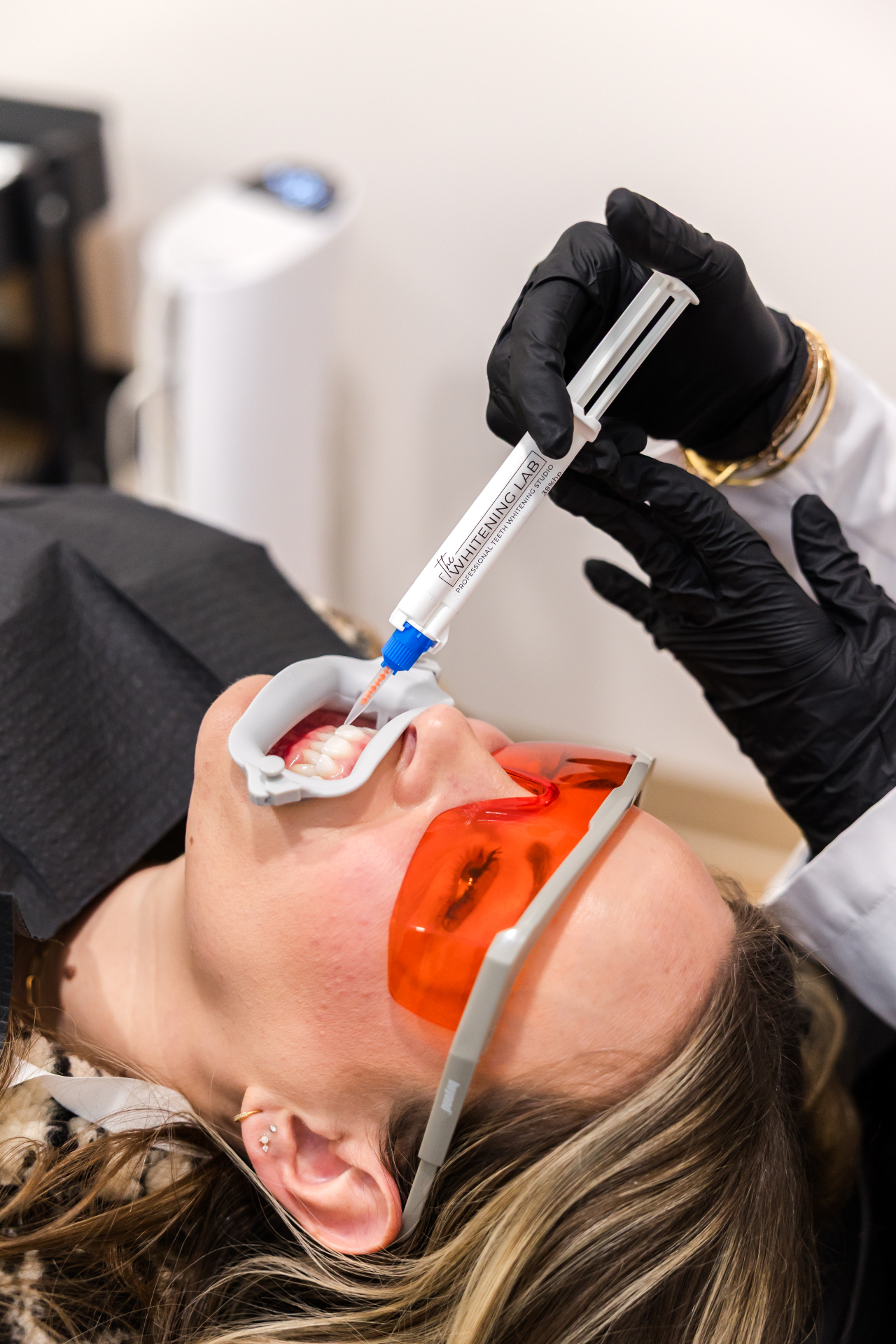 Client receiving a professional teeth whitening treatment at The Whitening Lab